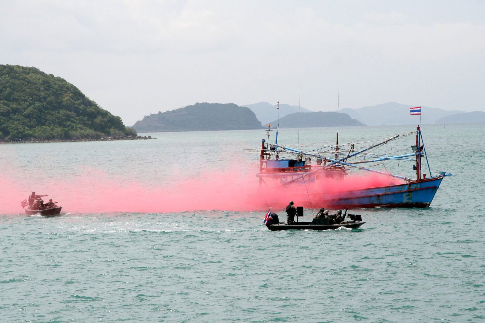 Royal Thai Navy assault boats simulate firing on a fishing vessel with red smoke during a harbor security drill at Sattahip, May 15, 2011, in CARAT Thailand 2011. (U.S. Navy photo by Ensign Lily Daniels)