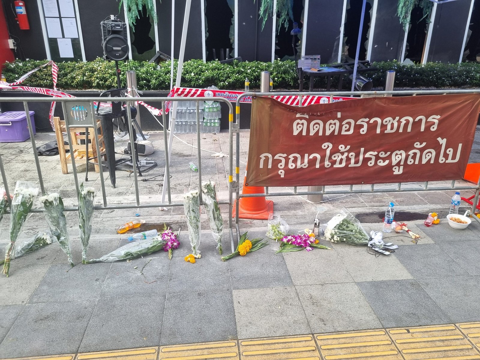 Flowers are placed near the scene of the deadly fire at Rong Beer Na Lat Phrao in Bangkok to honour the victims of the blaze that occurred on July 12, 2026. (SEA Daily/Puttipat Sawatdee)