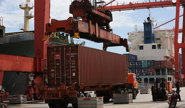 Cargo containers are loaded at a Cambodian port. (Khmer Times/Chor Sokunthea)
