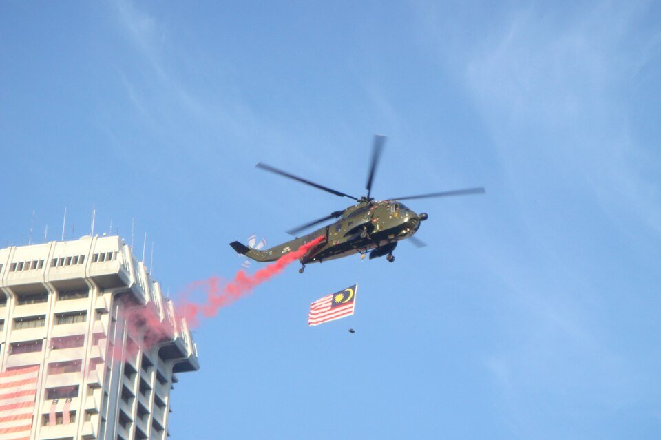 A Malaysian Armed Forces helicopter carries the national flag. (Wikimedia)